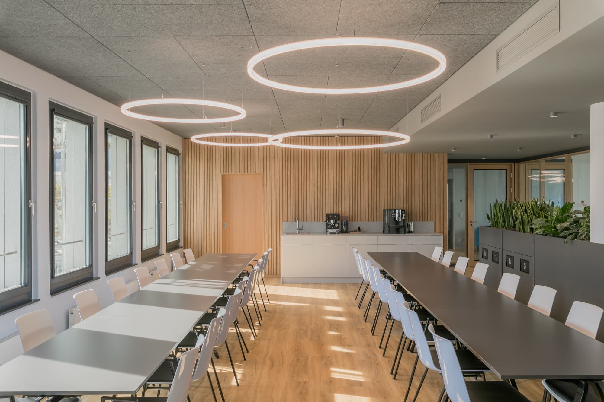 Oak acoustic panelling in a long meeting room at RIEM Arcaden, Munich